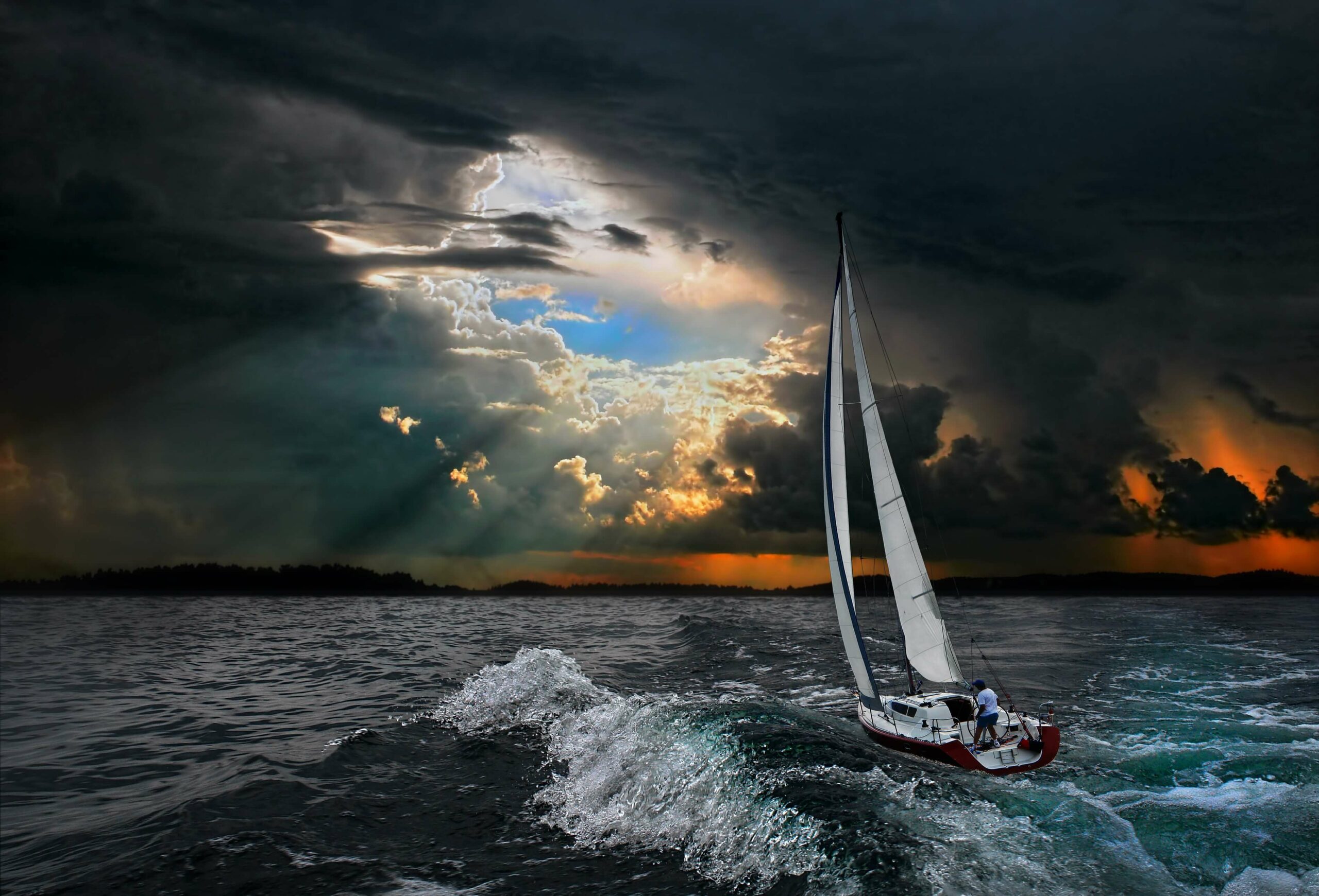 sailboat in storm break in clouds