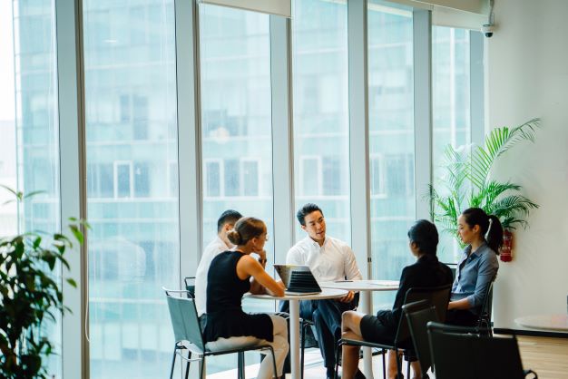 diverse group sitting around table having discussion