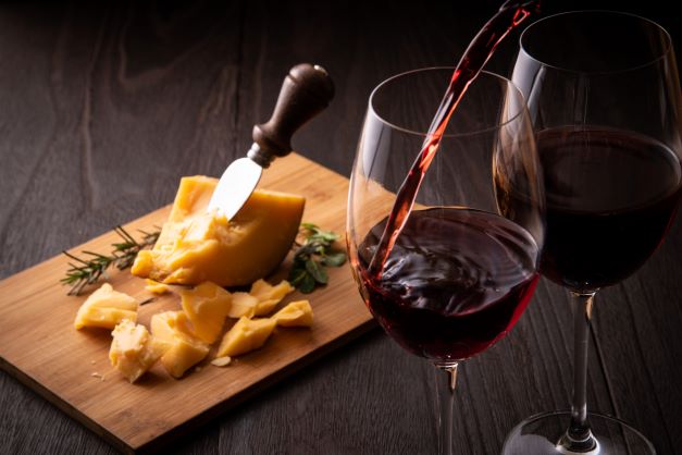 pouring red wine and cheese pairing